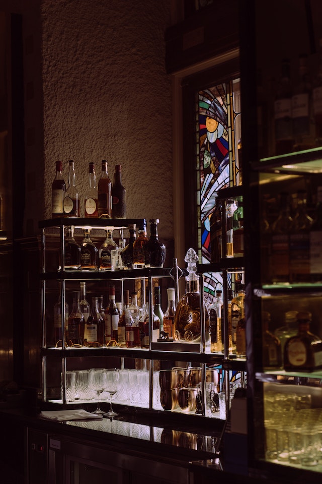 Whiskey bottles on shelves in a bar