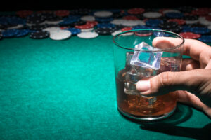 Casino or poker chips and whiskey on the rocks